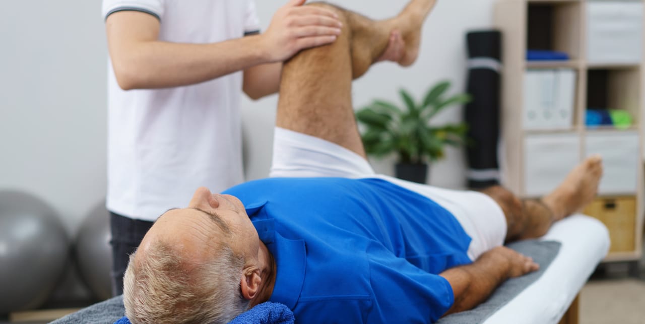 Physiotherapist helping a stroke survivor recover